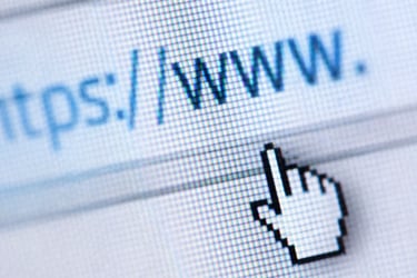 Close-up of a mouse cursor clicking on a secure HTTPS website address bar on a screen.