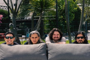 a group of four people sitting behind on a couch