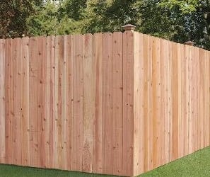 a fenced in backyard with a wooden fence