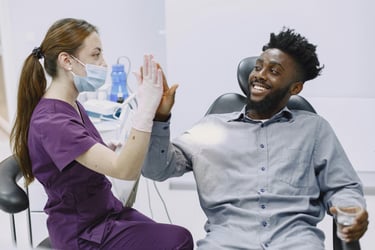smiling happy patient by the dentist