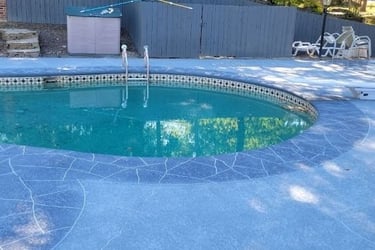a pool with a pool and a fenced in area