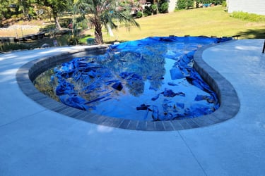 a pool with a blue tarp and a blue tarp