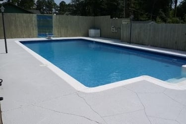 a pool with a fenced in area with a fenced in area