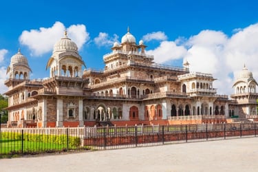 The Albert Hall Museum in Jaipur featuring Indo-Saracenic architecture under a bright blue sky.