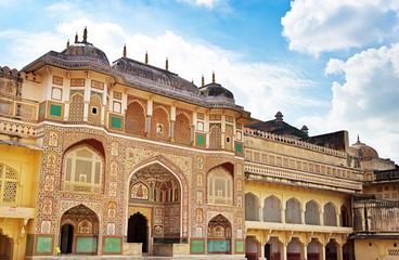 Ornate Ganesh Pol gateway at the historic Amer Fort in Jaipur, Rajasthan, showcasing intricate Rajput architecture.