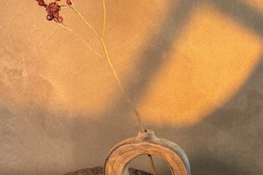 Handcrafted dark bamboo flower vase with a natural textured wood finish and traditional handle.