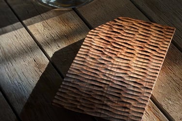Hand-carved rustic wooden vase displayed on a natural wood slice pedestal under warm sunlight.