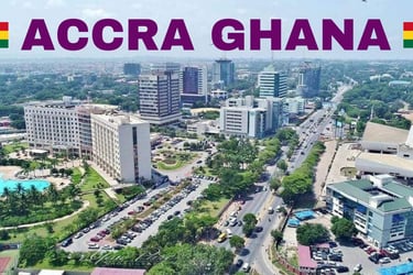 Aerial view of Accra Ghana city skyline with modern buildings, hotels, and busy streets.