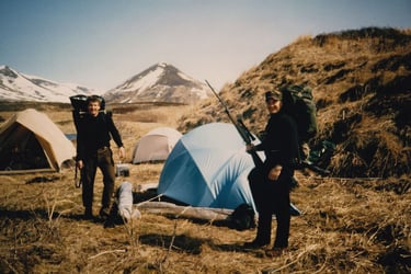 A&L Outdoors Alaska hunting base camp with multiple tents and hunters prepared for an expedition.