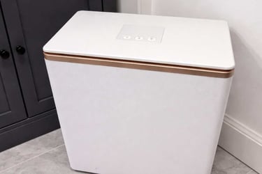 SereneLife towel warmer stands in a modern bathroom corner, displaying its compact and sleek design.