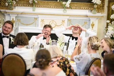 same-sex couple enjoying speeches after their wedding at The Trafalgar Tavern Greenwich