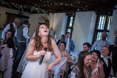 bride laughing during the speeches