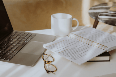 Woman reviewing notes and planning education goals at a desk