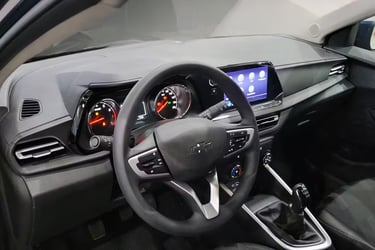 Interior view of a modern Chevrolet dashboard featuring a digital infotainment screen and manual gear shifter.