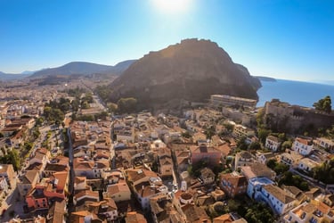 Aerial view of Nafplio old town and Palamidi Fortress under a bright sun in Greece.