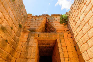 Ancient stone entrance at the Mycenaean Treasury of Atreus beehive tomb in Greece.