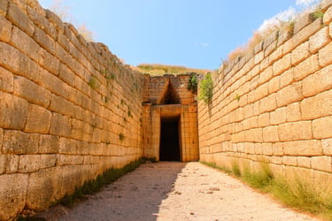 The ancient stone entrance to the Treasury of Atreus beehive tomb in Mycenae, Greece.