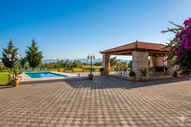 Tradition villa backyard with a blue swimming pool, stone patio, and covered outdoor dining pavilion