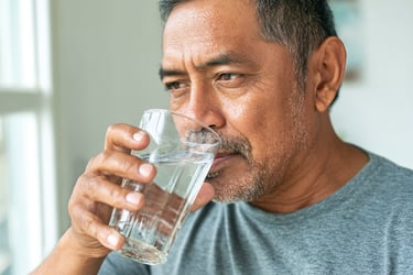 Man drinking water for healthy hair