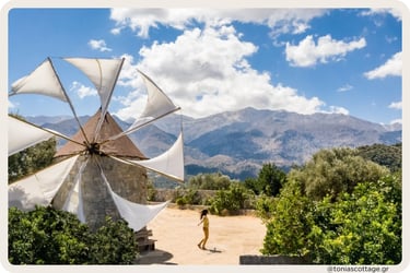 Woman dancing on the Lasithi Plateau in Crete, with a traditional windmill and mountain views