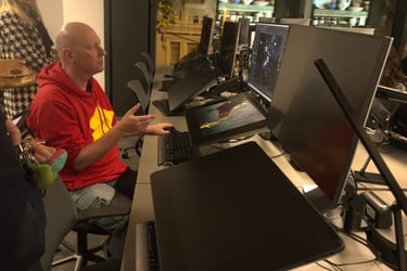 a man sitting at a desk with a laptop computer