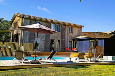 a house with a pool and a deck chair