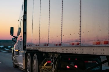 Trucking image representing driver misclassification, unpaid wages, miles, and detention pay cases