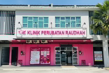 Exterior of Klinik Perubatan Raudah medical clinic featuring a pink storefront and signage.