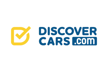 DiscoverCars.com logo featuring a yellow checkmark icon on a black background for car rental bookings.
