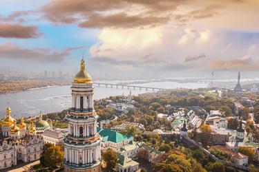 Panoramic aerial view of the golden-domed Kyiv Pechersk Lavra monastery and Dnieper River in Ukraine.