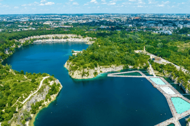 Aerial view of Zakrzowek quarry lake in Krakow featuring blue water and floating swimming pools.