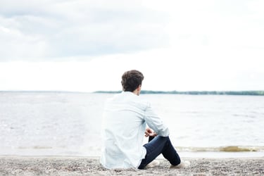 man sitting alone struggling with his challenges in life