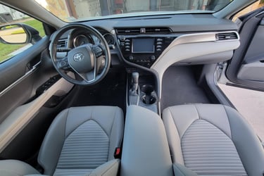 The interior light gray of a toyota camry after a mobile detailing service