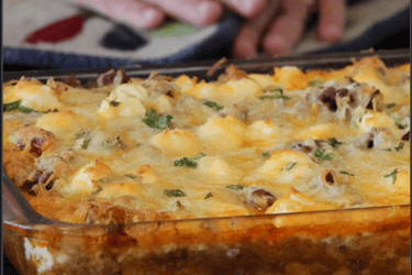 a casserole dish with cheese topping a delicious taco pie