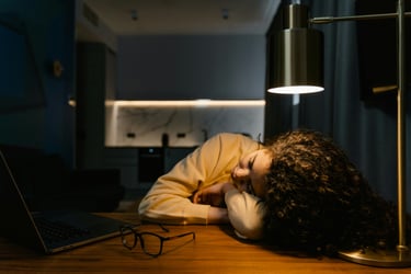 Tasha sleeping at the table, after a night of researching the best ways to make money from home.