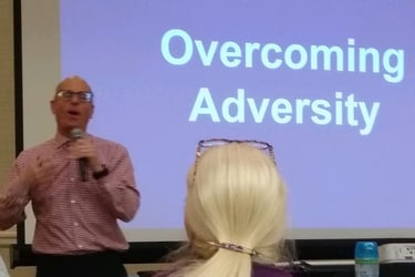 Image is of David D'Arcangelo Speaking in front of a corporate audience talking about disability inc