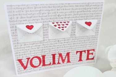 Greeting card with three small envelope designs on textured script background. Each envelope has red