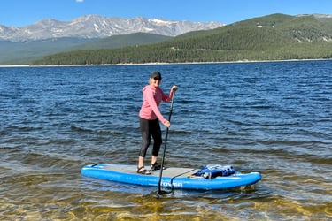 Behavioral psychologist and menopause coach Becca Borden paddling rough waters in the mountains