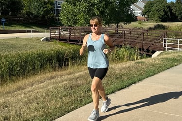 behavioral psychologist and menopause coach Becca Borden using strong muscles to run outside