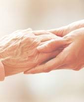 a woman holding a hand of a man's hand. Trusted Medicare Resource