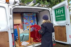 a lady taking items out of a van