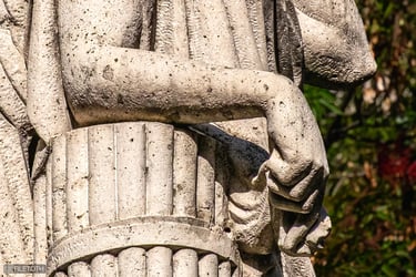 Close up on the hand of 'La Pace', fingers gently extended in a gesture of peace.