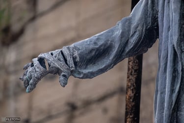 Close-up of where a hand should be, focusing on the empty robe to symbolize a vanished person.