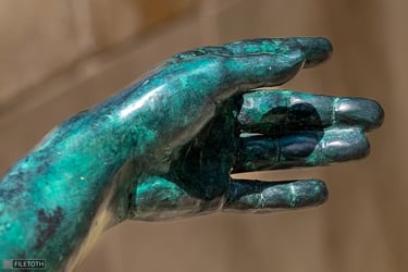 Close-up of Keleti’s left hand, fingers elegantly and precisely arranged.