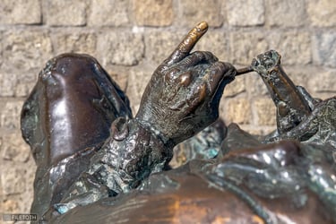Overhead view of Hilda Gobbi’s bronze hand, little finger pointed with precise gesture.