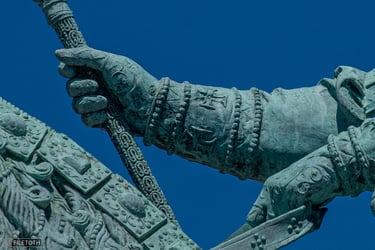 Close-up of Saint Stephen's gloved hand holding an ornate double cross.