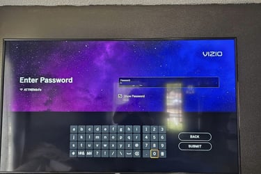 Vizio smart TV screen displaying a password entry keyboard over a purple galaxy background.