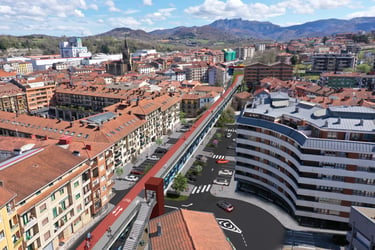 Aerial view of a modern urban bike path and pedestrian walkway integrated into a European city landscape.