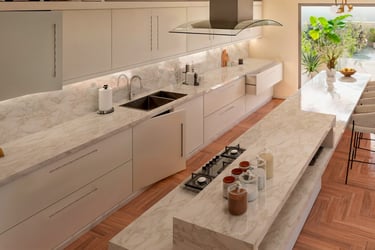 Modern luxury kitchen featuring white marble countertops, a large island with seating, and sleek minimalist cabinetry.