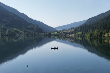 droneshot fisherboat men feld am see lake